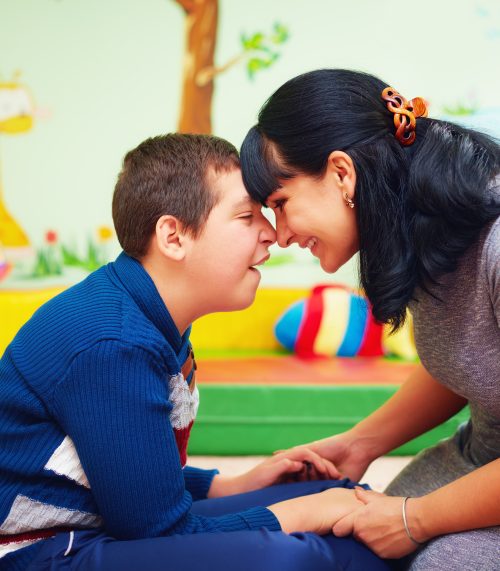 soulful moment. portrait of mother and her beloved son with disability in rehabilitation center